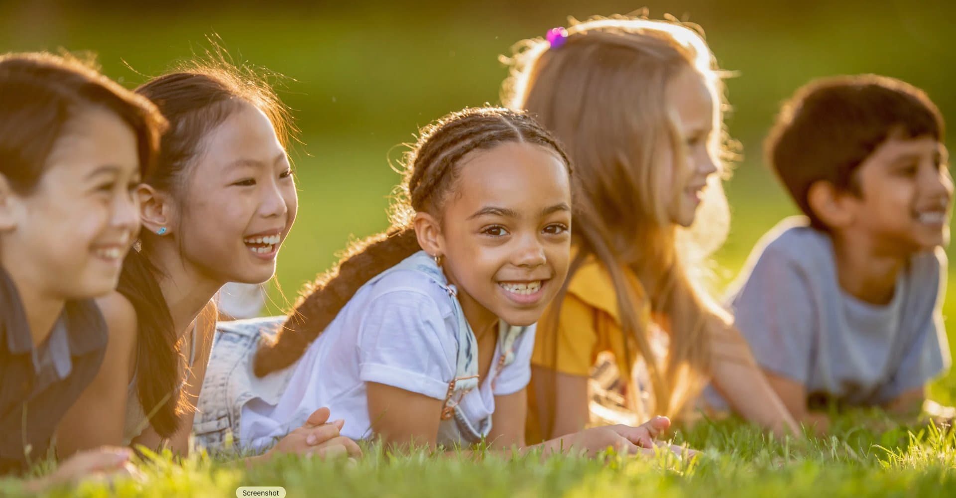 Children laughing together outdoors — the joy that drives our mission
